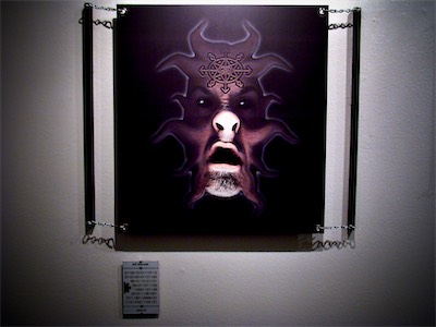 Evil Incarnate | Gallery Photo — I really enjoyed the fact that I was able to put this up in a gallery show somewhere. Partly because it was such an old piece, and it is so viscerally revolting on so many levels, just an absolute distortion of a human figure. And it really, literally is just my face pressed directly against a standard image scanner. But considering how many people allow themselves to become monsters in their struggle to find relevance in the public eye, I think it's definitely doing exactly what it's supposed to when you see it in a show like this in a gallery.