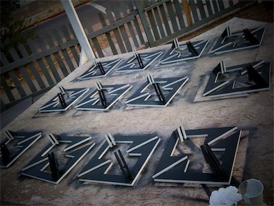 Chaos Sculpture II | Painting 1 — Now we're outside on the stage in the front yard at the gallery. I guess I didn't take too many process shots of painting itself, but here you get to see all of the finished painted pieces laying out and drying. Black on the flat parts, white on the edges. Made sense to me to give it the most contrast.