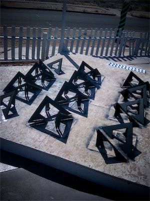 Chaos Sculpture II | Painting 2 — Of course, I had to get other edges as well that I didn't have access to while they were all laying down. So, now they're tilted up and drying after being painted. And in the background, you can see a whole bunch of the connecting L-bracket hardware, all painted white, drying on the side that they're on.