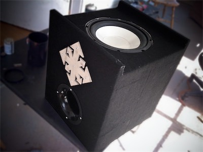 Chaos Subwoofer — And of course, it makes sense to actually show how the sub is mounted. You can see it there now, with the sub upside down and the bottom unscrewed. The sub is down firing. I believe it's an Infinity 10W30, and it wallops. I do need a new amp for it, though. It's an old class AB amp, and it just couldn't handle the brutal bass I put through it. I need a class D amp for it.