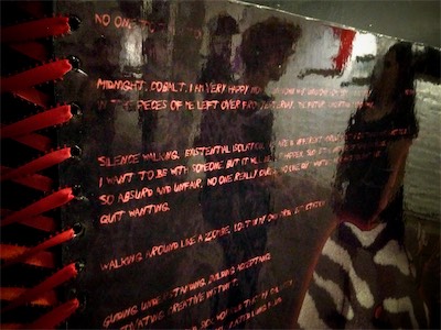 Transparency — Close-up in-gallery shot. Technically, you might think that it's so you could see people in the reflection, but it's more so so you could read a little bit of what it's saying.