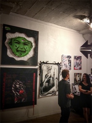 Transparency & Tolerance — During the show. The woman on the right is the artist showing right next to me, with that black piece next to mine, talking to some other person browsing the art.