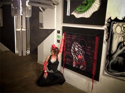 Transparency — That is Mecca, and I think she went out of her way to come to the show dressed in exactly those colors because she knew that this piece was going to be showing. Now we get to see her posing in a number of different ways with the artwork of her.