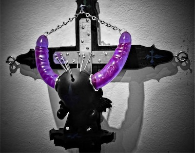 Sacred the Munny — In this shot, I'm just trying to get a little bit of a close-up on some of the main details. The crosses painted onto the ends of the main cross, with the one at the top being painted on upside down, and one more on the pedestal that this Munny doll is standing on. The rings, cock rings if you like, on either side of the head, acting to hide a bit of the cutaway into the head. The crown of screws. The Prince Albert piercings. It's an intense sculpture.