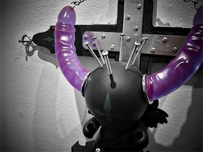 Sacred the Munny — Well, since it was such a shitty camera, might as well get a close-up here. Even got some purple reflections in those steel plates. You can really see those screws going into his head, and that veiny texture in that double-ended dildo. This honestly was a very fun project to build.